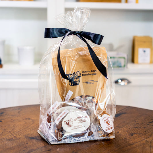 Gift bag with Tennessee Valley Pecan Company products on a wooden table.