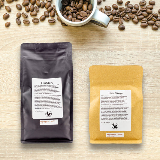 Two coffee packages labeled 'Our Story' on a wooden surface with scattered coffee beans.