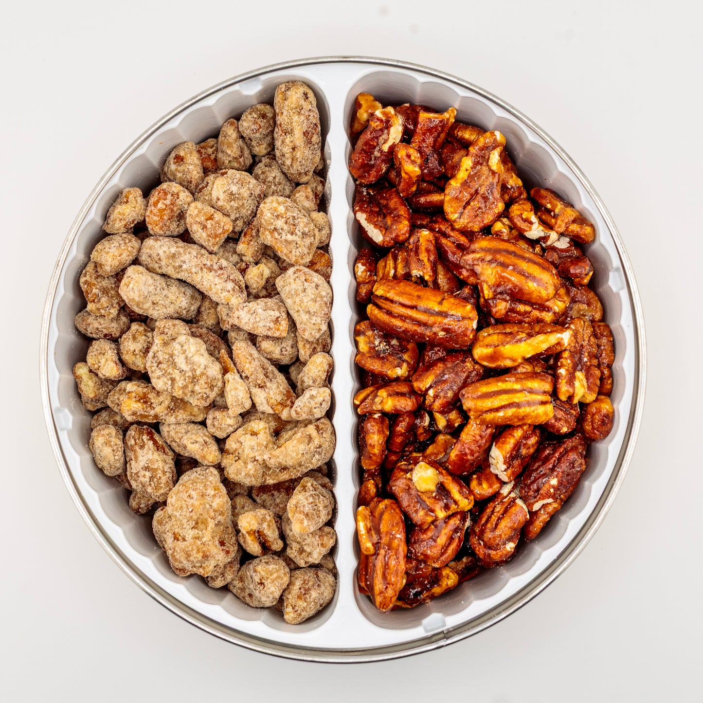 Praline and Honey-Glazed Pecans in a gift tin on a white background