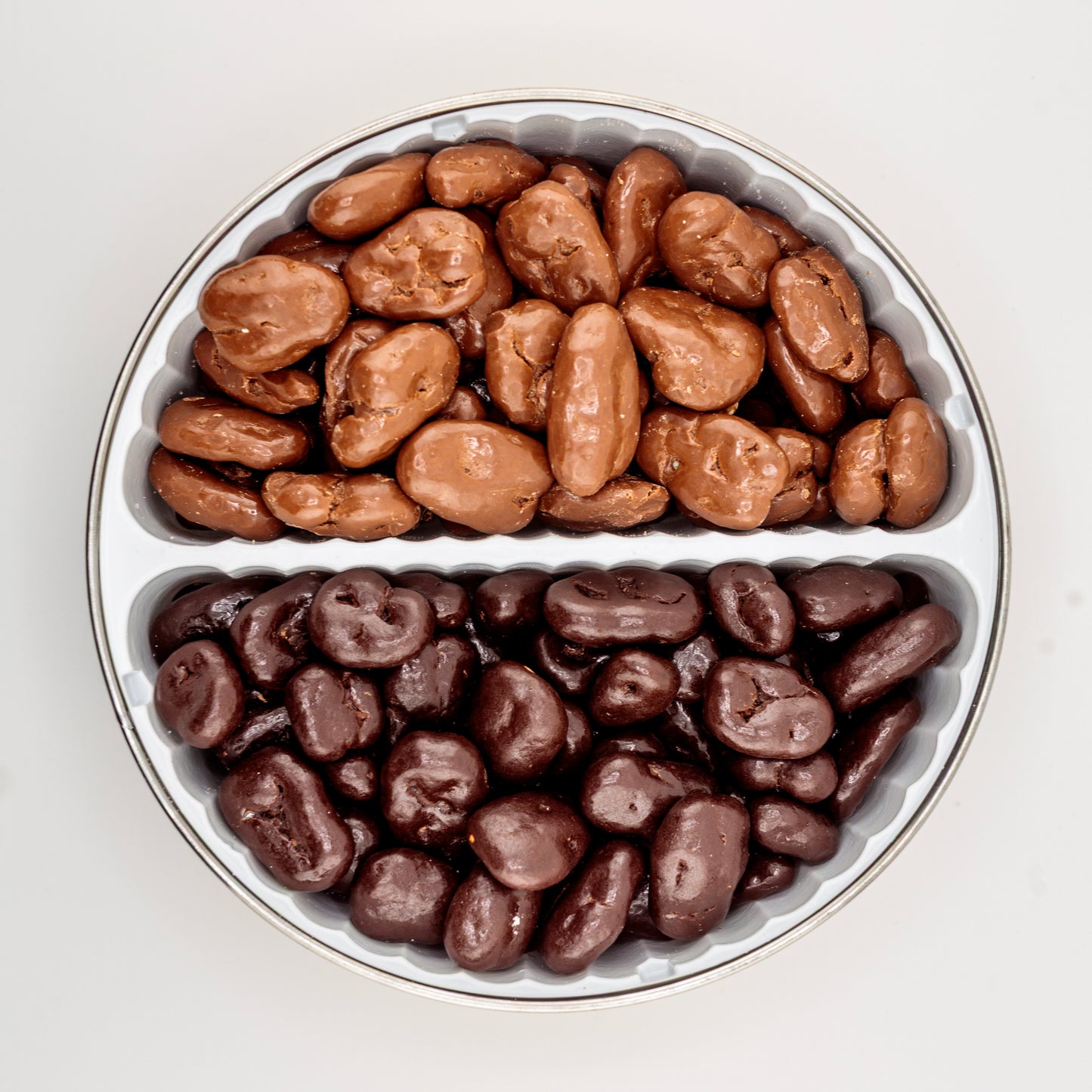 Milk Chocolate and Dark Chocolate Pecans in a gift tin on a white background