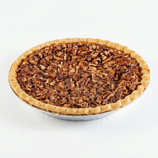 A whole pecan pie in a silver foil pie tin, photographed from a top-down angle on a clean white background.