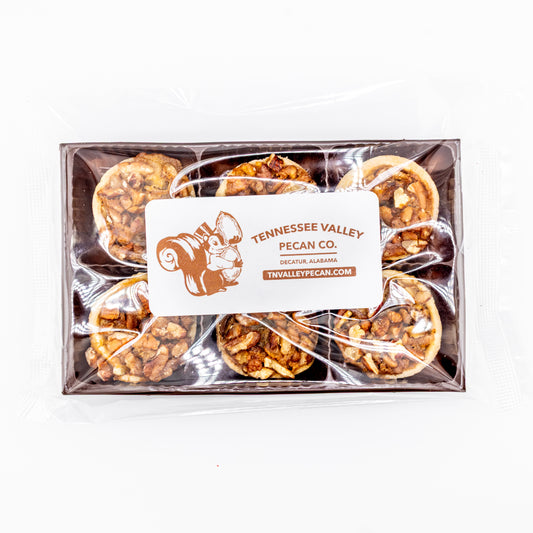 Box of Tennessee Valley Pecan Co. pecan pie bites with cleart packaging on a white background