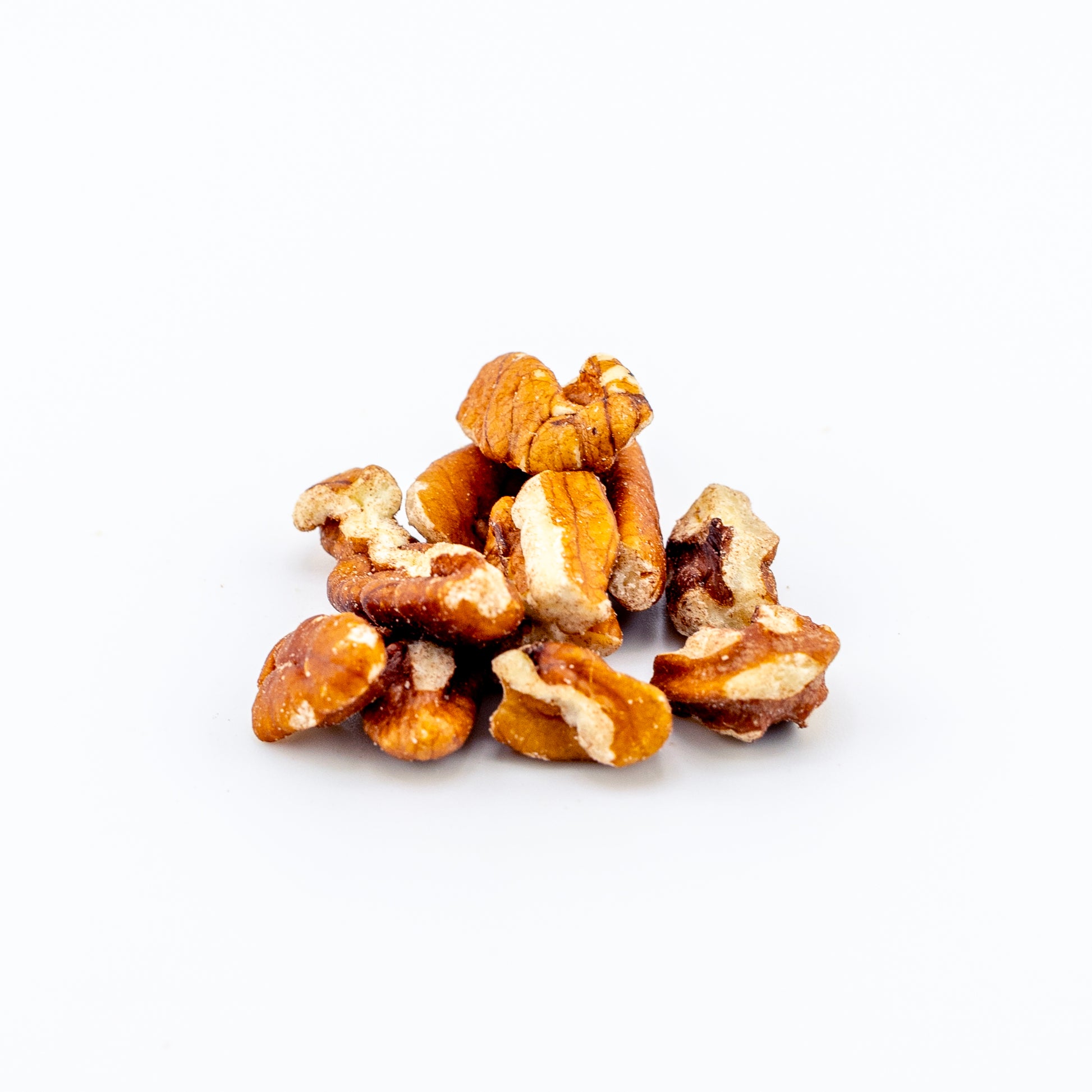 Pile of Large Pecan Pieces on a white background