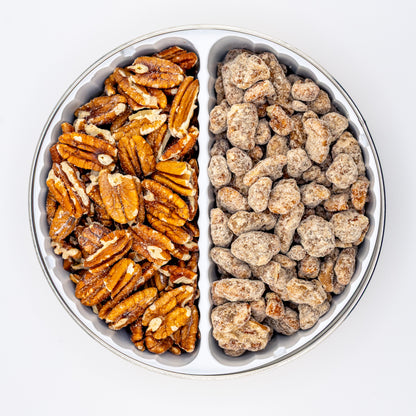 Praline and Toasted pecans in a divided tin on white background.