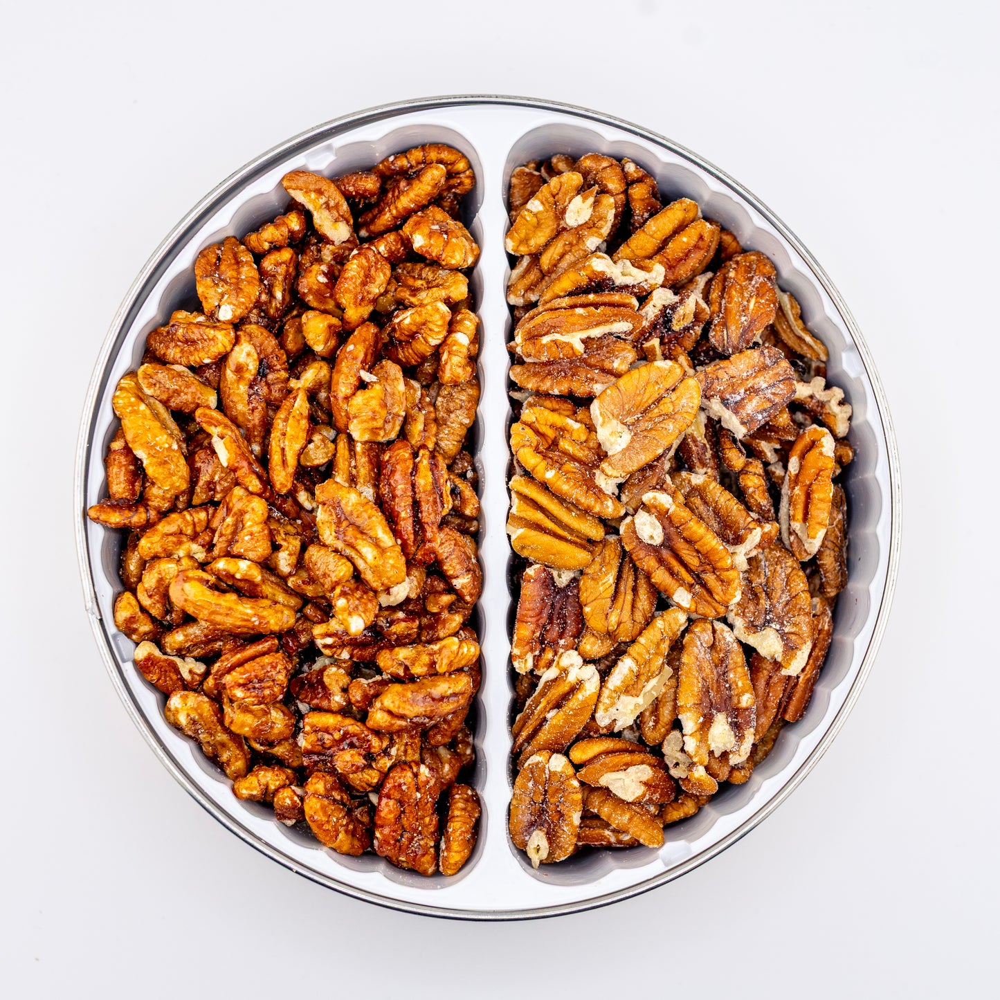 Toasted and Sweet Heat Pecans in a divided tin on white background.