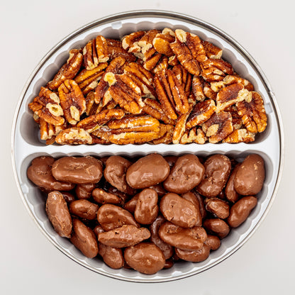 Toasted and Milk Chocolate Pecans in a gift tin on a white background