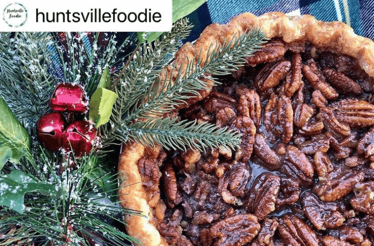 overhead image of bourbon pecan pie with holiday decor