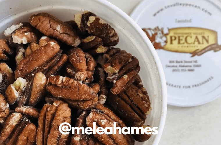 overhead image of toasted pecans in quarter gallon container