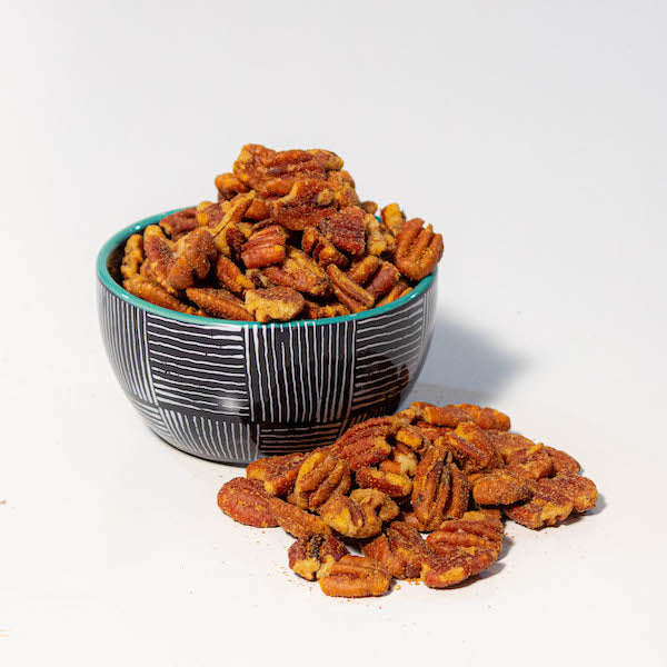 spicy pecans in bowl on white counter